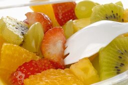 Fruit salad in a plastic box (close-up)