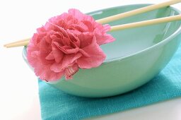 Asian bowl with chopsticks and flower