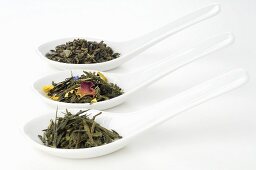 Three different sorts of tea in porcelain spoons