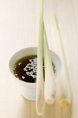 Lemon grass on small bowl of soy sauce