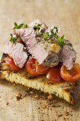 Beef steak with cherry tomatoes on toasted bread