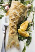 Fried sea bass with herbs, garlic and lemon