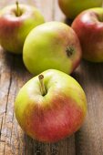 Several fresh apples on wooden background