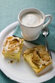 Two pieces of apple meringue cake with coffee
