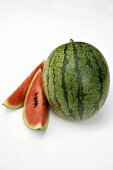 Whole watermelon and two slices of watermelon