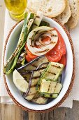 Grilled vegetables, white bread & olive oil (overhead view)