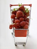 Assorted berries in toy shopping trolley