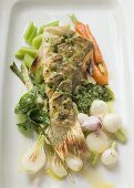 Fried sea bass with pesto on vegetables