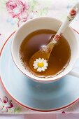 Chamomile tea in cup with spoon