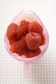 Fresh raspberries in pink jug