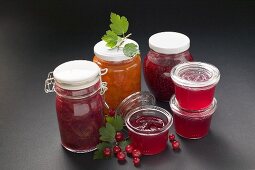 A selection of jams & jelly in jars, redcurrants & leaves