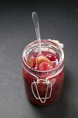 Gooseberry jam in jar with spoon