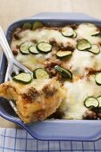 Polenta bake with mince and courgettes, portion on server