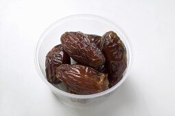 Dried dates in plastic dish