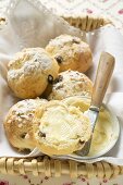 Sugared raisin scones with butter in bread basket