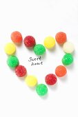 Coloured jelly sweets forming heart with the words 'Sweet heart'