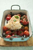 Monkfish with cherry tomatoes and olives in roasting tin