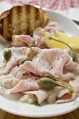 Cold roast pork with capers, lemon and toasted bread