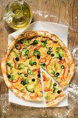 American-style vegetable pizza, a slice cut, olive oil