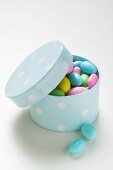 Coloured sugared almonds in blue box