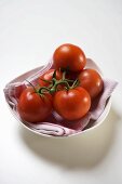 Fresh tomatoes in white bowl