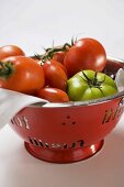 Various types of tomatoes in a colander