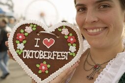 Woman with Lebkuchen heart (Oktoberfest, Munich)