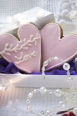 Two heart-shaped Christmas biscuits to give as a gift