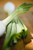 Spring onions on wooden background