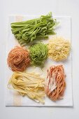 Home-made coloured pasta on tea towel