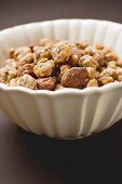 Mixed nuts to nibble in white bowl