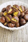 Roasted chestnuts in white bowl