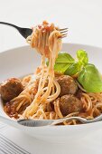Spaghetti with meatballs, tomato sauce and basil