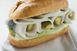 Herring, onions and gherkins in bread roll