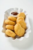 Chicken nuggets with dip in paper dish