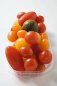 Various types of tomatoes in plastic tray
