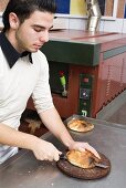 Young chef cutting pita bread