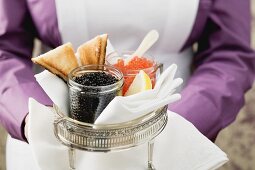 Chambermaid serving caviar and toast