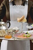 Chambermaid serving luxury breakfast tray