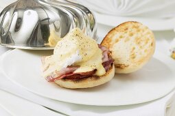 Eggs Benedict on plate with dome cover