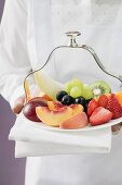 Waitress serving a plate of fruit