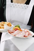 Waitress serving ham and white bread