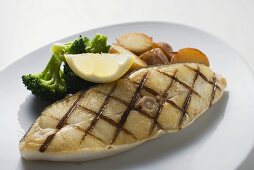 Grilled cod steak with potatoes and broccoli