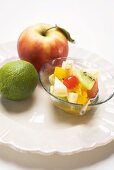 Fruit salad, apple and lime on plate