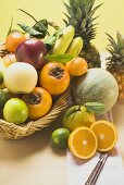 An assortment of fresh fruit, partly in basket