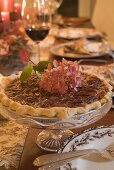 Pecan pie on table laid for Thanksgiving (USA)