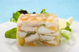 Jellied fish, garnished with salad leaves