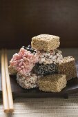 Asian sweets on wooden plate with chopsticks