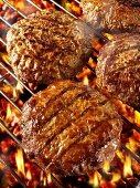 Burgers on barbecue rack