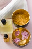 Bath products, flowers in bowl of water, towel